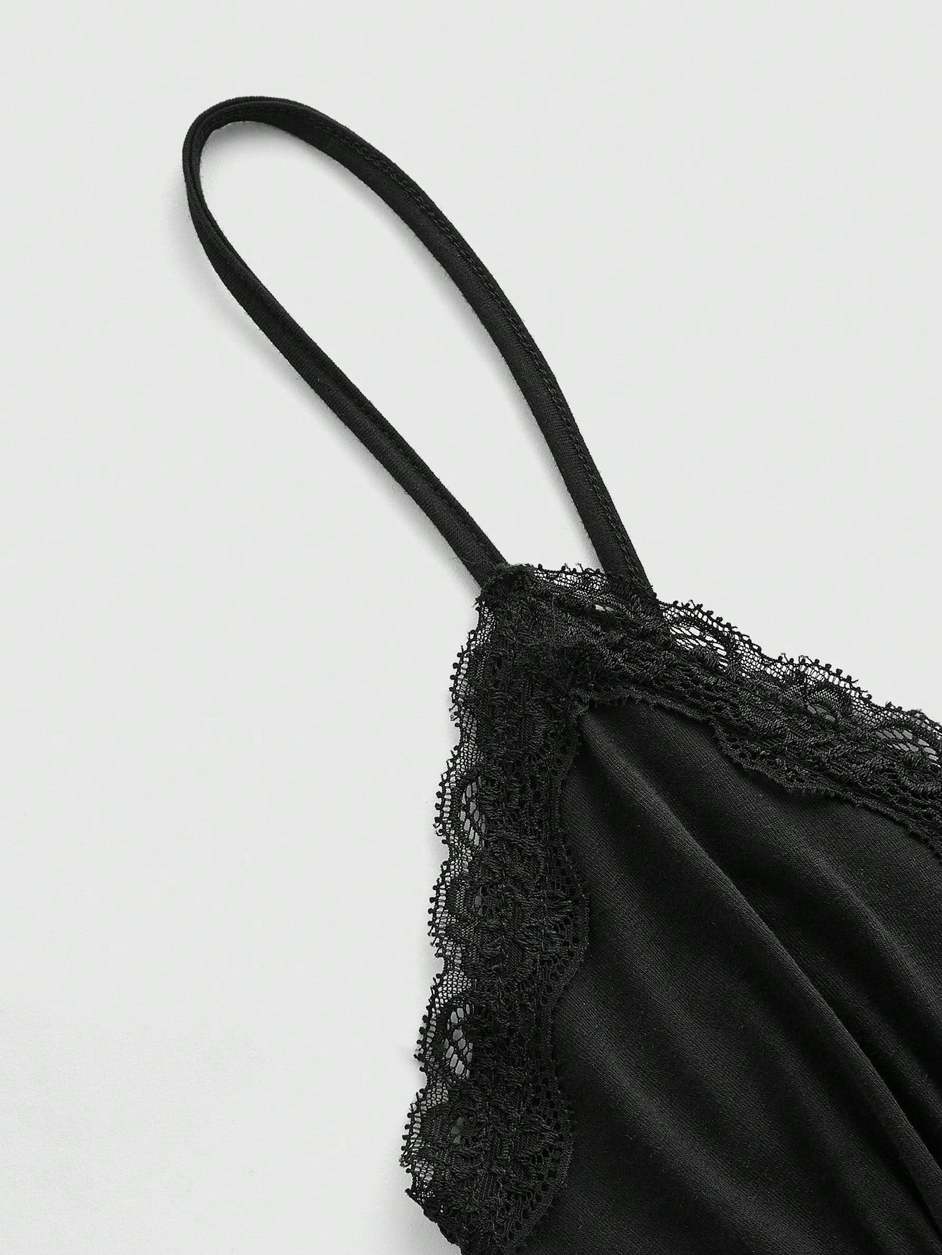 Women's spaghetti strap camisole with contrast lace patchwork, slim fit silhouette, plain design, and flared hem.