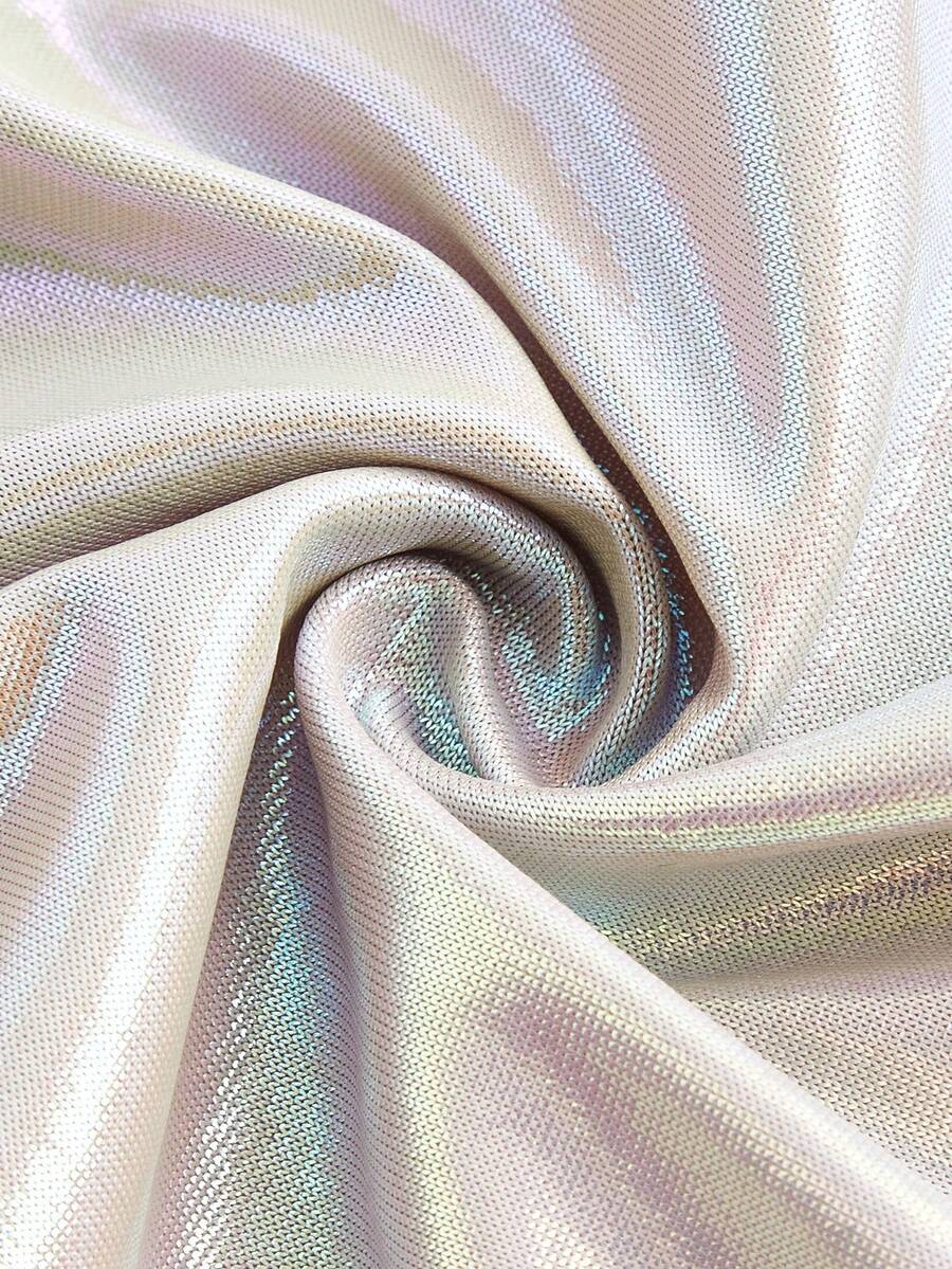 Holographic metallic two-piece set with a spaghetti strap hanky hem crop cami top and drawstring side skirt, featuring ruched details and rhinestone accents.