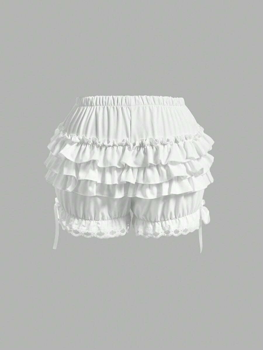 Women's tiered ruffle skort shorts featuring an elastic mid waist with front tie knot detail in woven fabric.