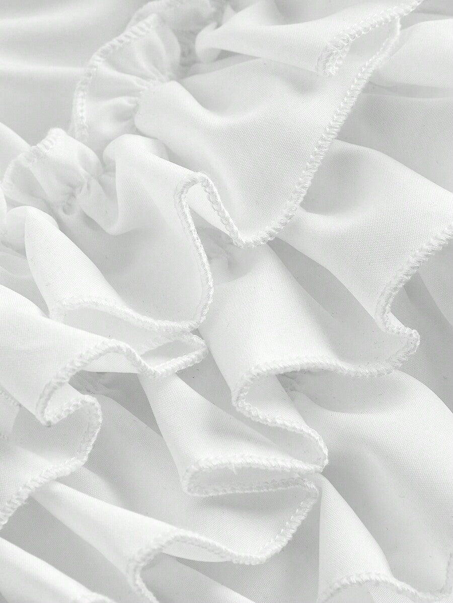 Women's tiered ruffle skort shorts featuring an elastic mid waist with front tie knot detail in woven fabric.