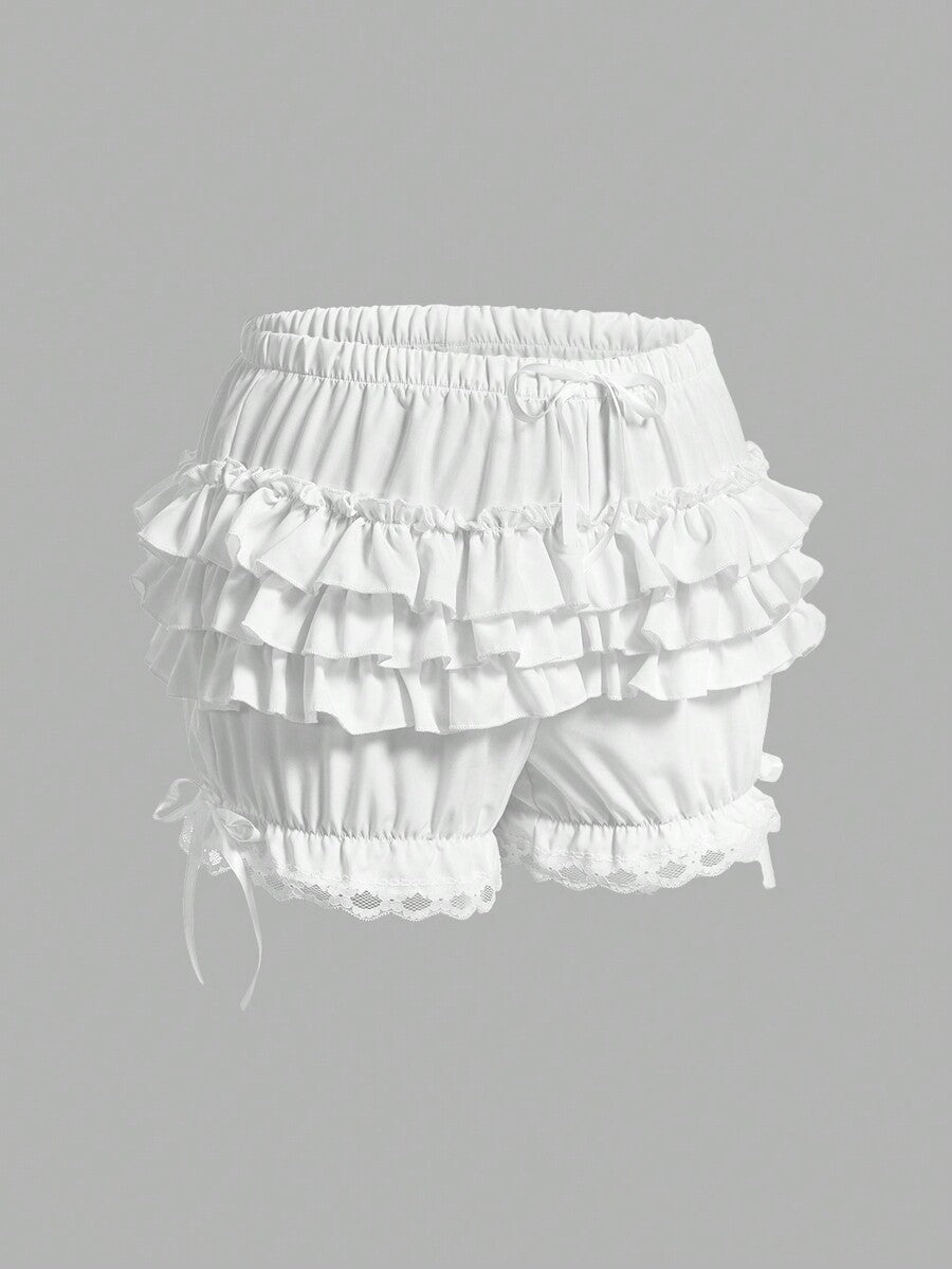 Women's tiered ruffle skort shorts featuring an elastic mid waist with front tie knot detail in woven fabric.