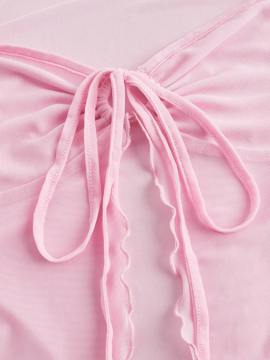 Semi-sheer mesh top featuring a sweetheart neckline with front knot detail, long flare sleeves, lined body, and an asymmetrical hem.