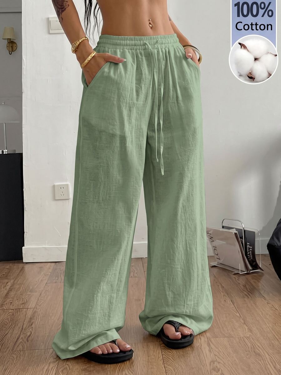 Plus size women's striped loose straight leg cropped pants with pleated detailing and side pockets