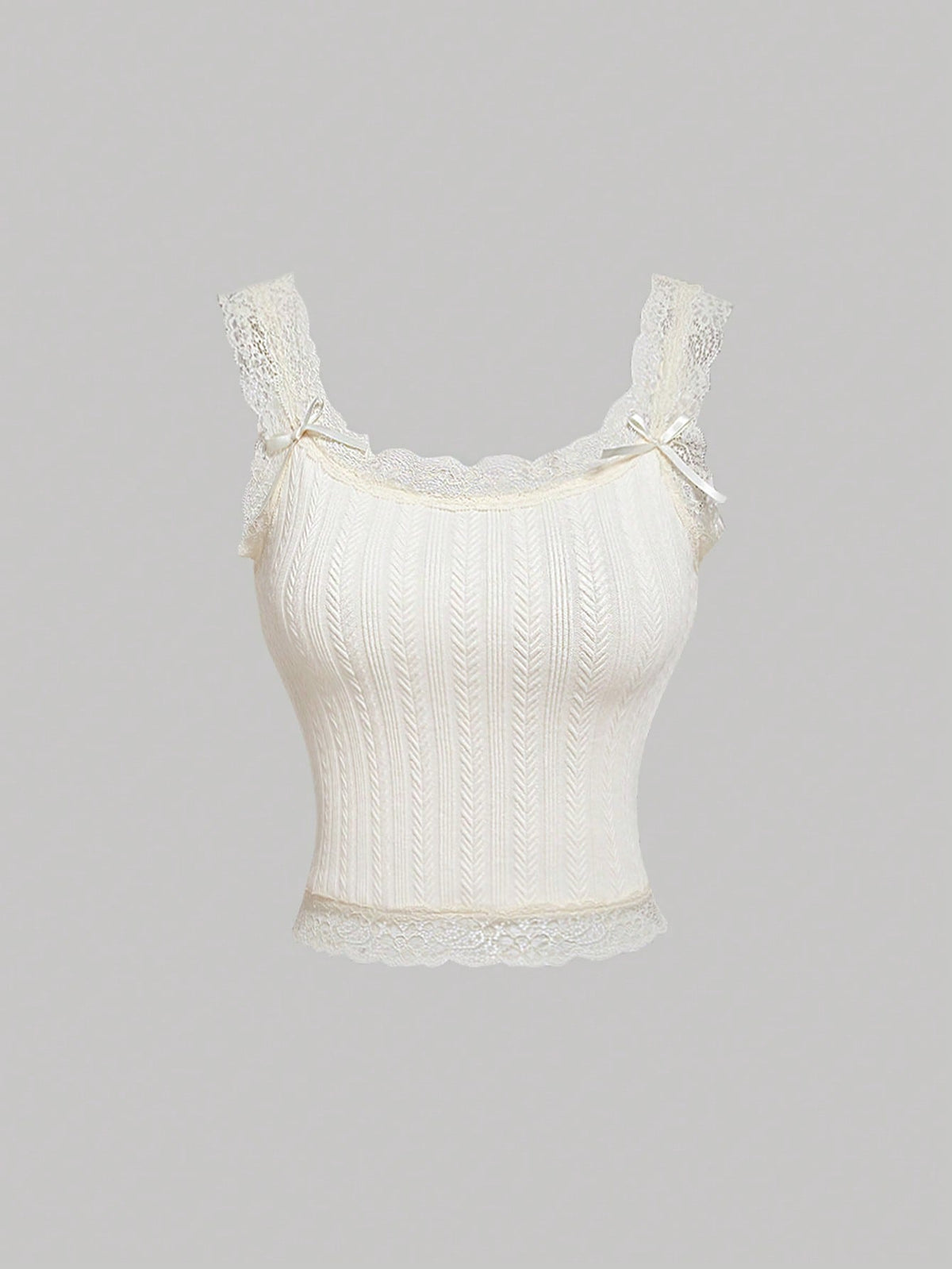 Black jacquard textured camisole top featuring contrast lace trim, bow decoration, scoop neck, and wide shoulder straps.