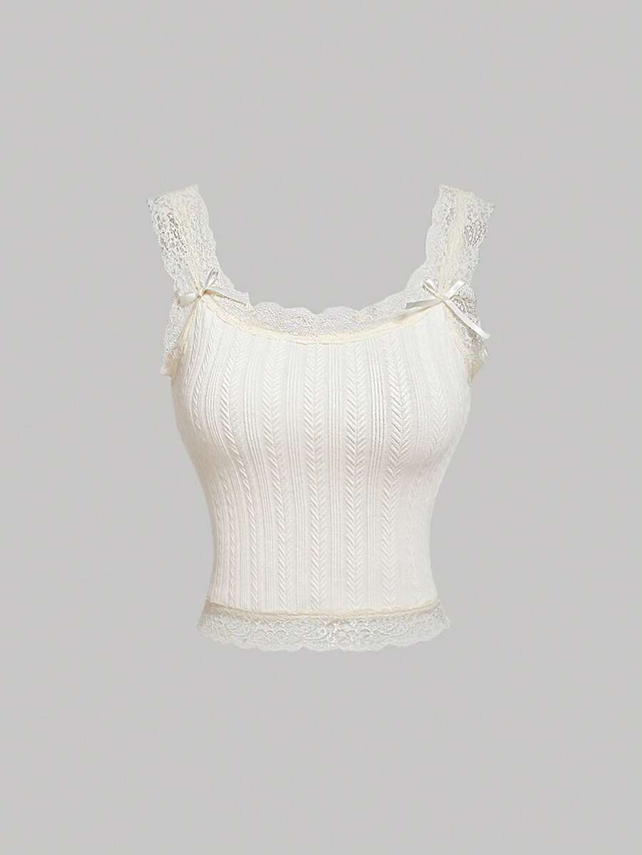 Black jacquard textured camisole top featuring contrast lace trim, bow decoration, scoop neck, and wide shoulder straps.