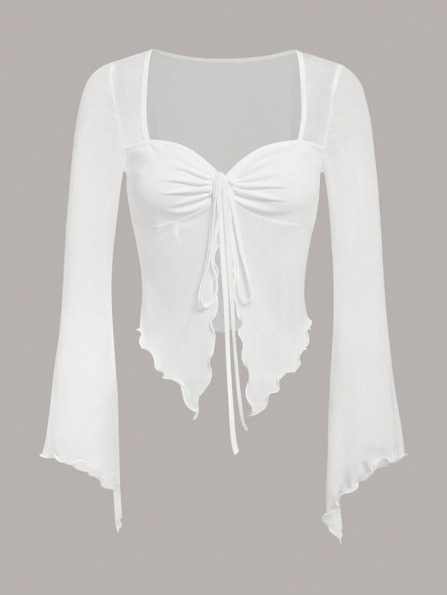 Semi-sheer mesh top featuring a sweetheart neckline with front knot detail, long flare sleeves, lined body, and an asymmetrical hem.