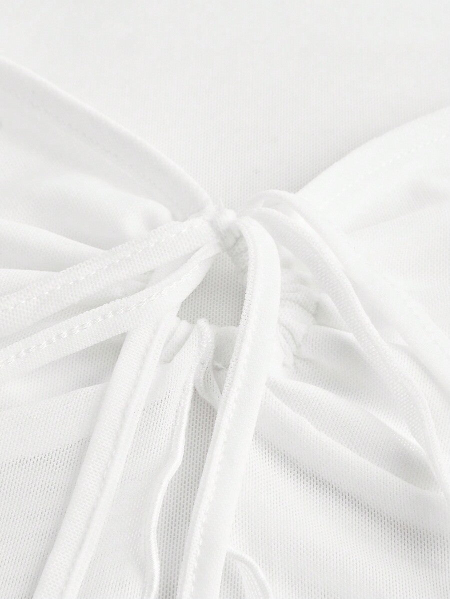 Semi-sheer mesh top featuring a sweetheart neckline with front knot detail, long flare sleeves, lined body, and an asymmetrical hem.