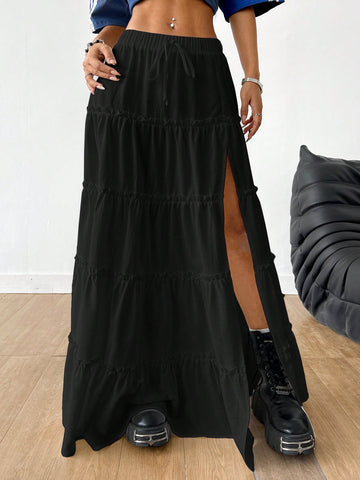 Women's black maxi bubble skirt featuring a high thigh split, lettuce ruffle trim, and a relaxed flared silhouette.