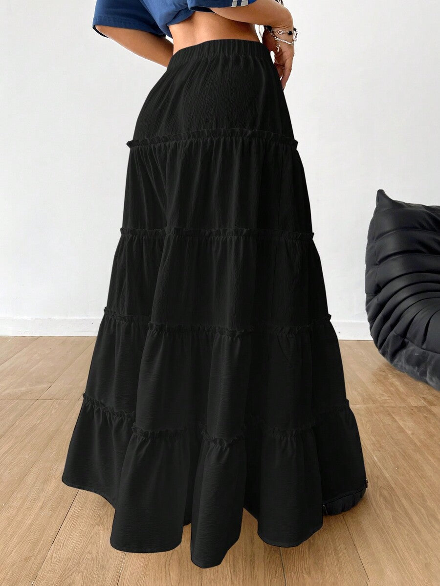 Women's black maxi bubble skirt featuring a high thigh split, lettuce ruffle trim, and a relaxed flared silhouette.