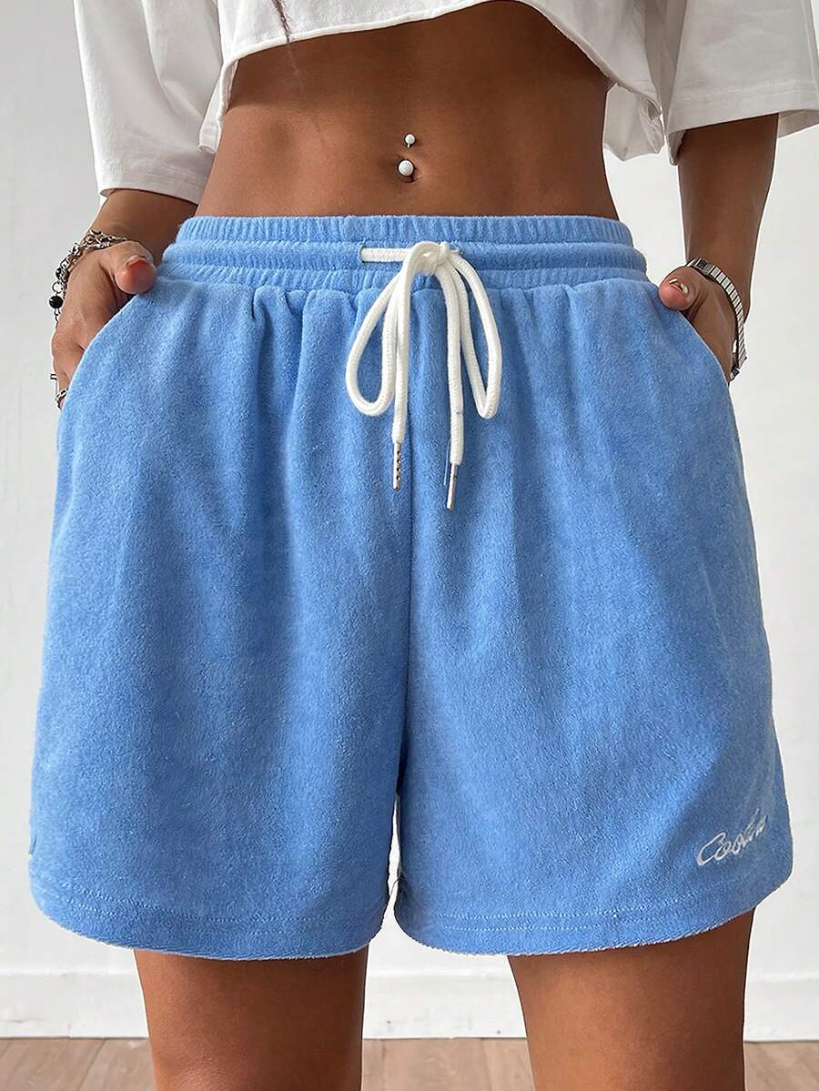 Women's casual drawstring track shorts featuring front pockets and embroidered details
