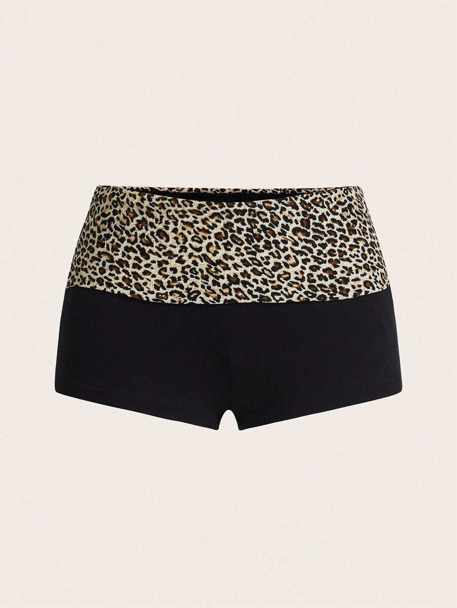 Leopard print foldover waist ultra low rise mini shorts with elastic waistband, skinny fit, and short length.