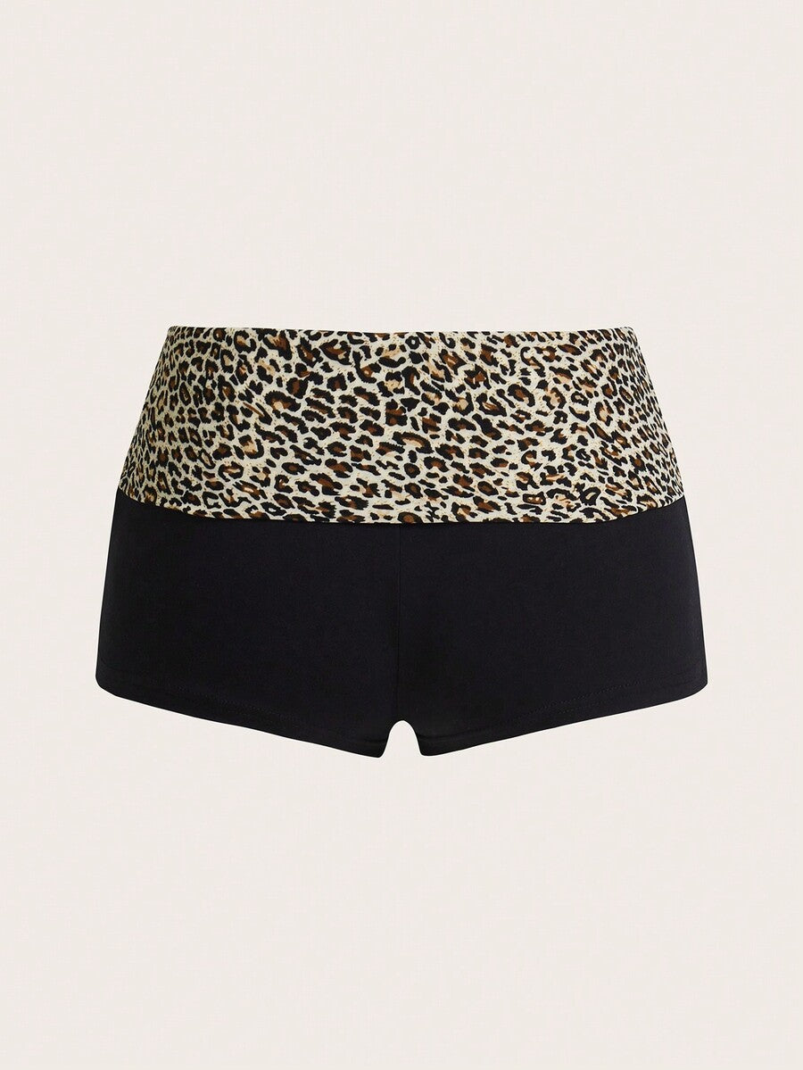 Leopard print foldover waist ultra low rise mini shorts with elastic waistband, skinny fit, and short length.
