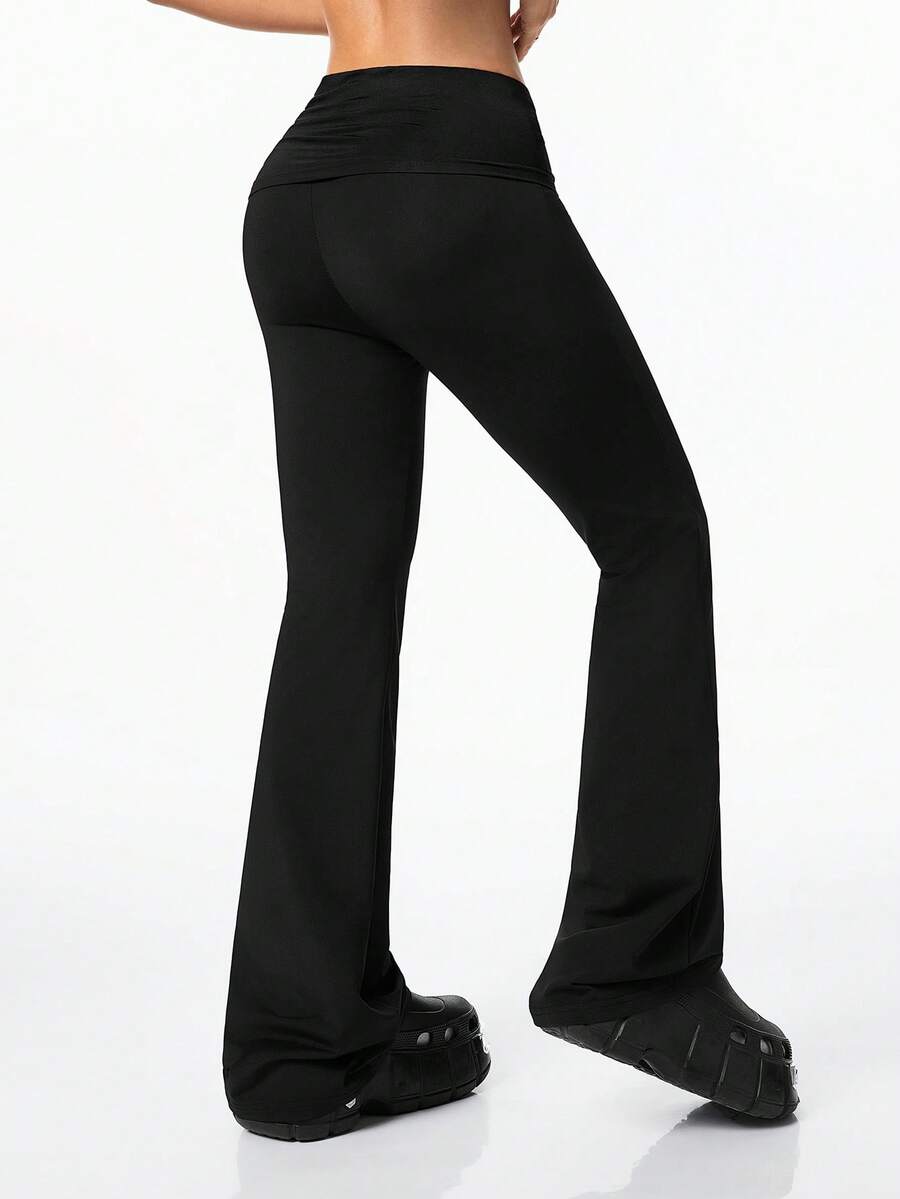Women's black and white polka dot flare leg pants with side drawstring and ruched details