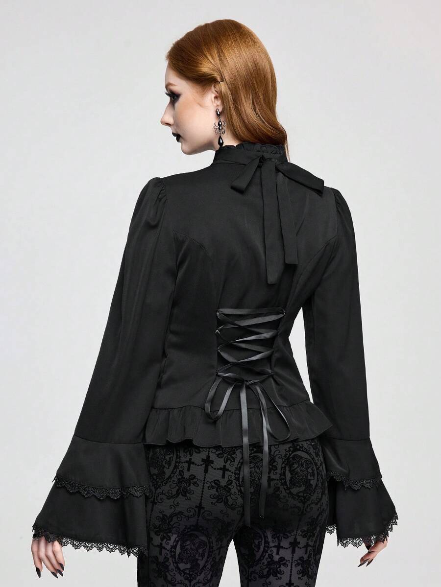 Vintage gothic style women's blouse with stand collar, detachable ruffled bow tie, gem pendant, and flare sleeves