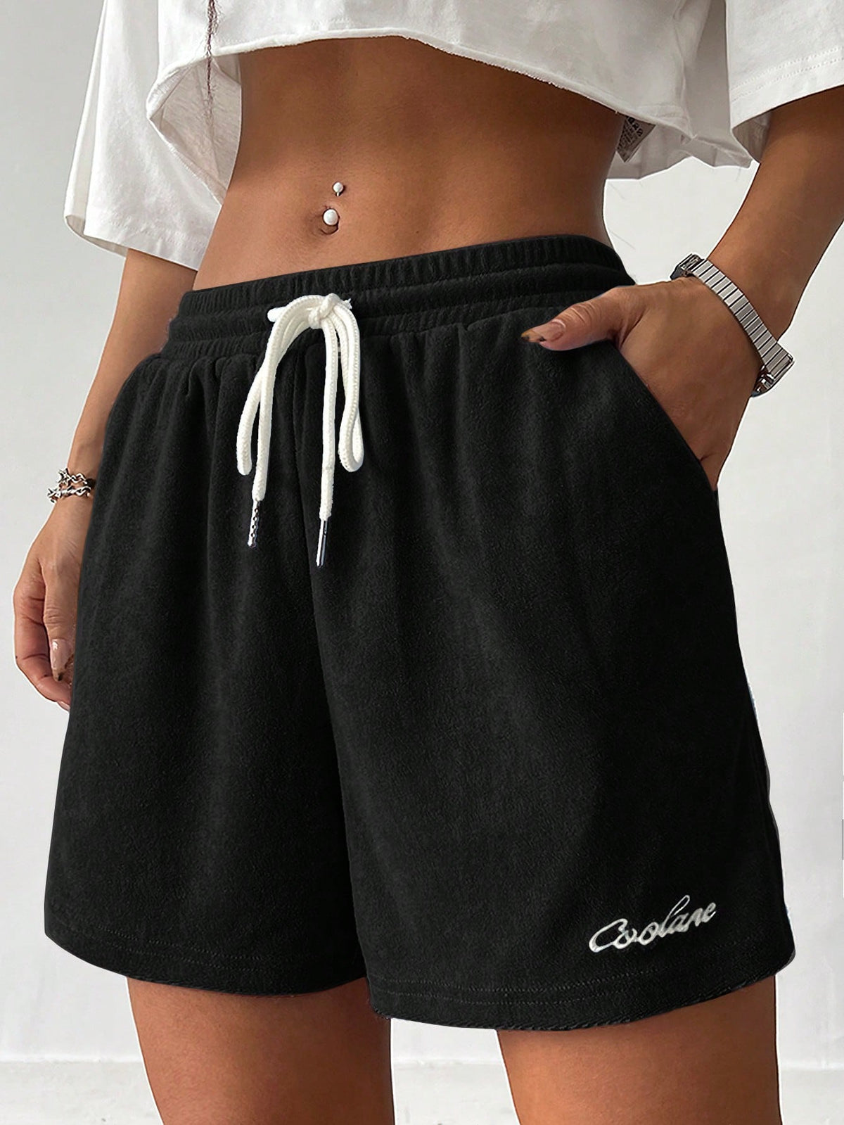 Women's casual drawstring track shorts featuring front pockets and embroidered details