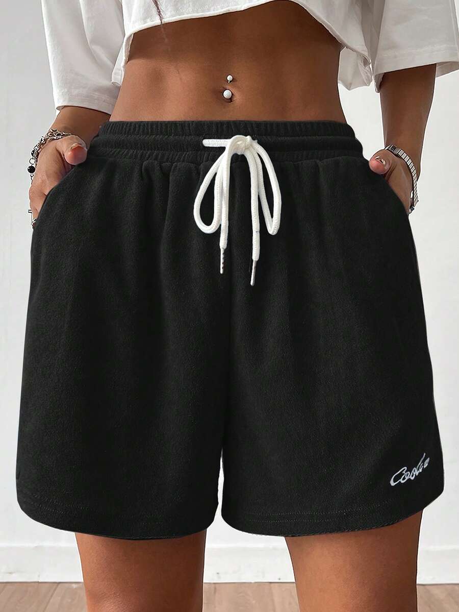 Women's casual drawstring track shorts featuring front pockets and embroidered details