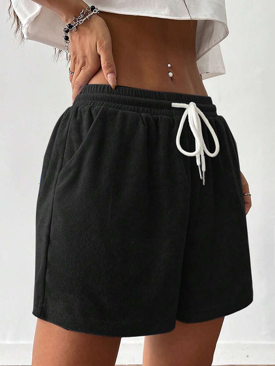 Women's casual drawstring track shorts featuring front pockets and embroidered details