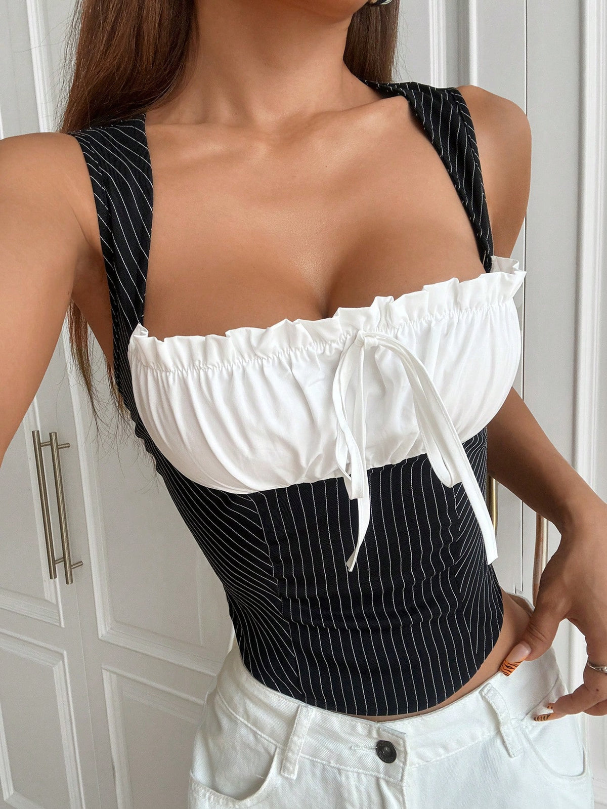 Women's multicolor striped fitted camisole top featuring wide straps, a ruched bust with frill and front tie detail.