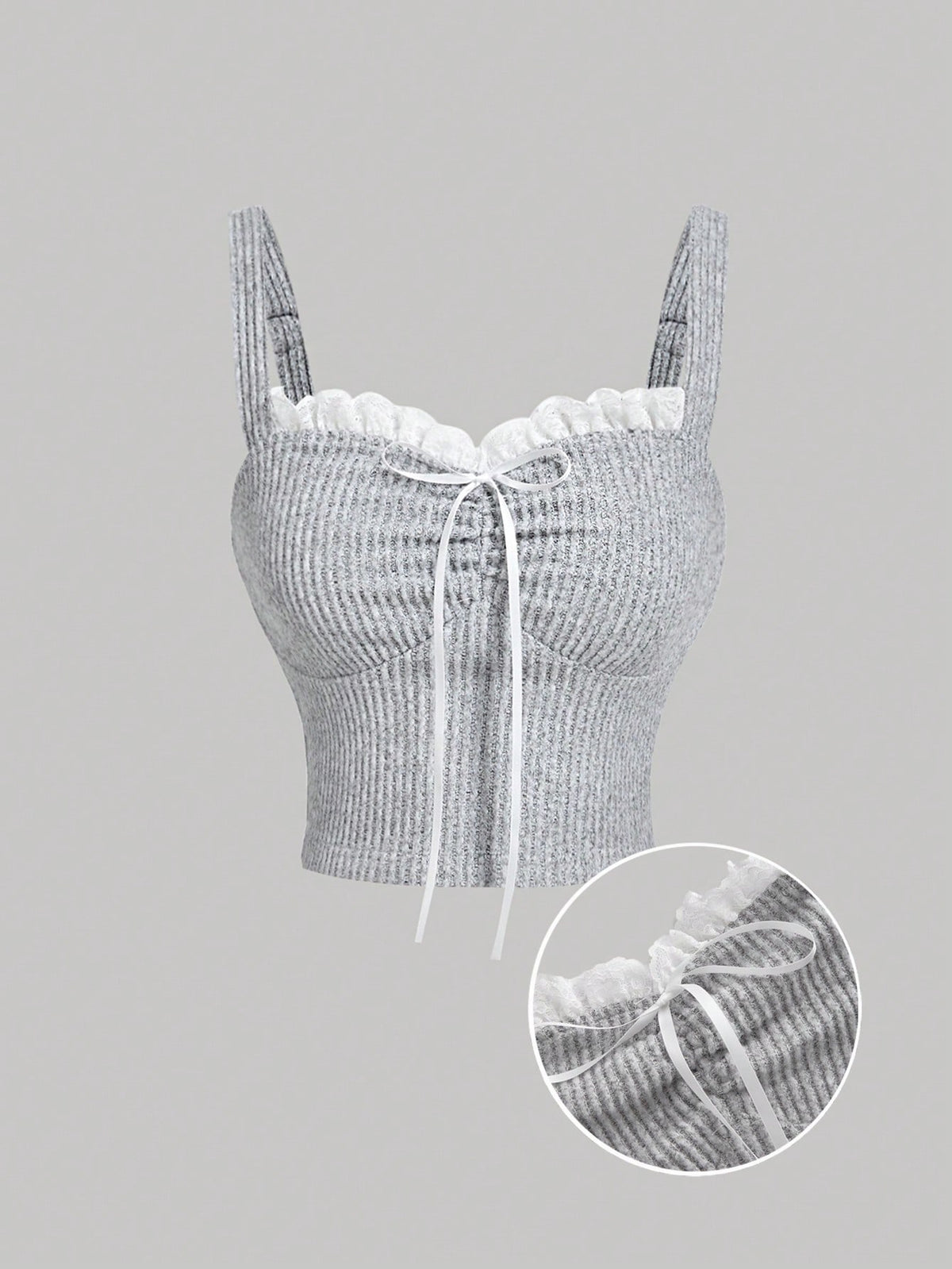 Black crop camisole top for women featuring shoulder straps, cold shoulder sleeves, drawstring detail, and frill trim on plain knitted fabric.