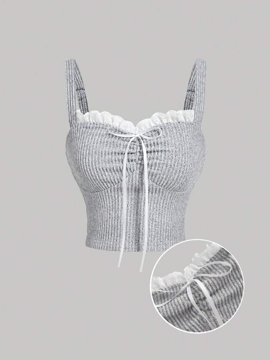 Black crop camisole top for women featuring shoulder straps, cold shoulder sleeves, drawstring detail, and frill trim on plain knitted fabric.