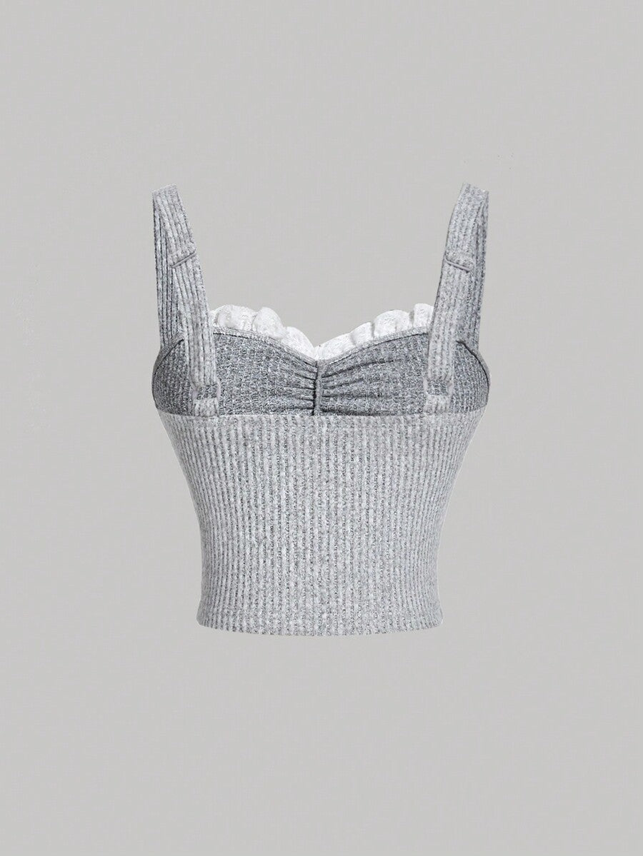 Black crop camisole top for women featuring shoulder straps, cold shoulder sleeves, drawstring detail, and frill trim on plain knitted fabric.