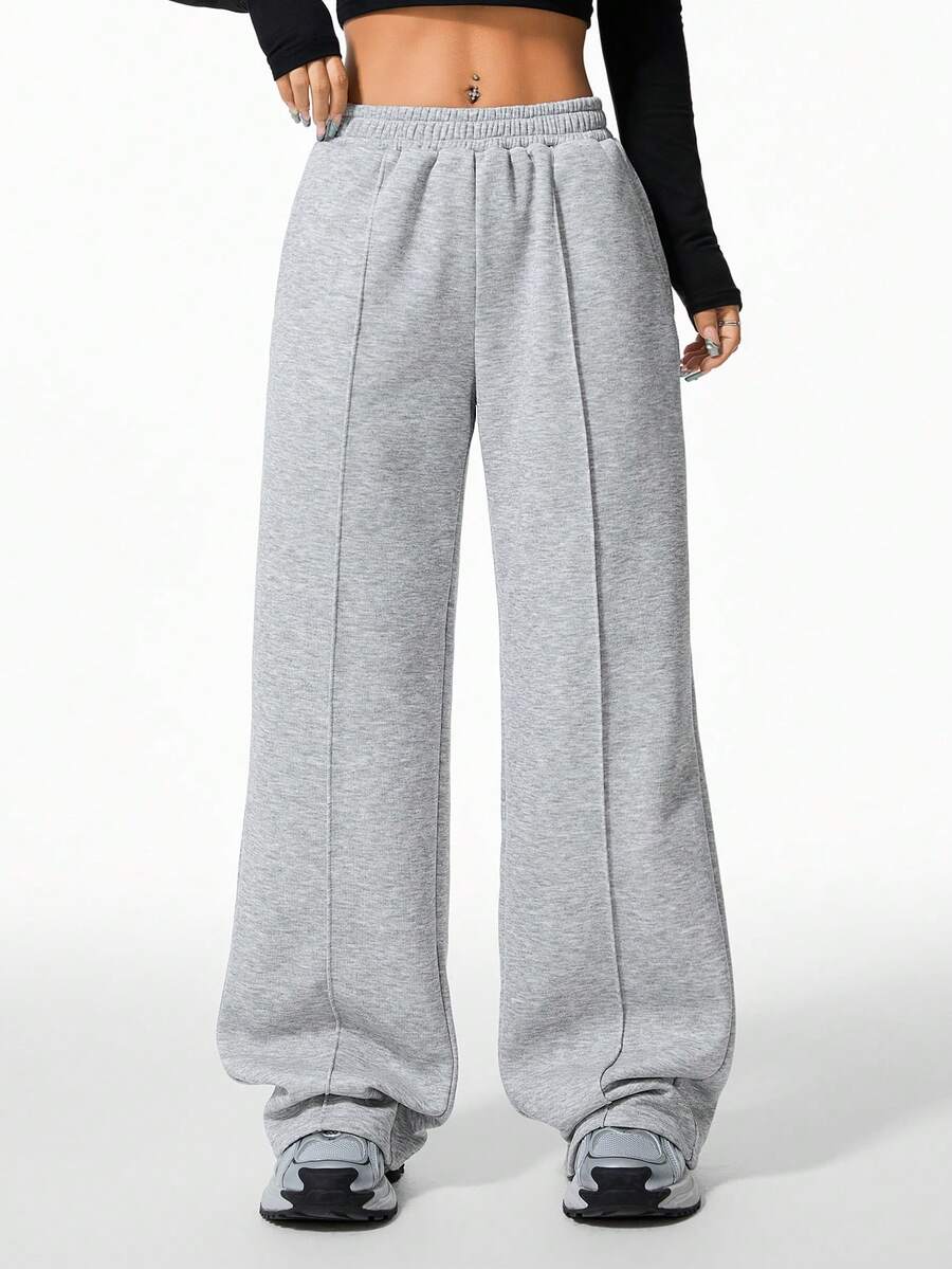 Women's grey fleece straight-leg sweatpants featuring a loose fit and elastic waistband.