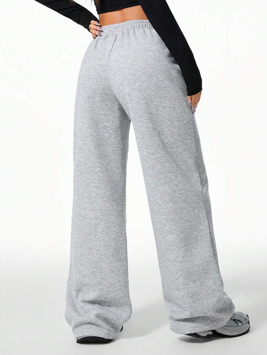 Women's grey fleece straight-leg sweatpants featuring a loose fit and elastic waistband.