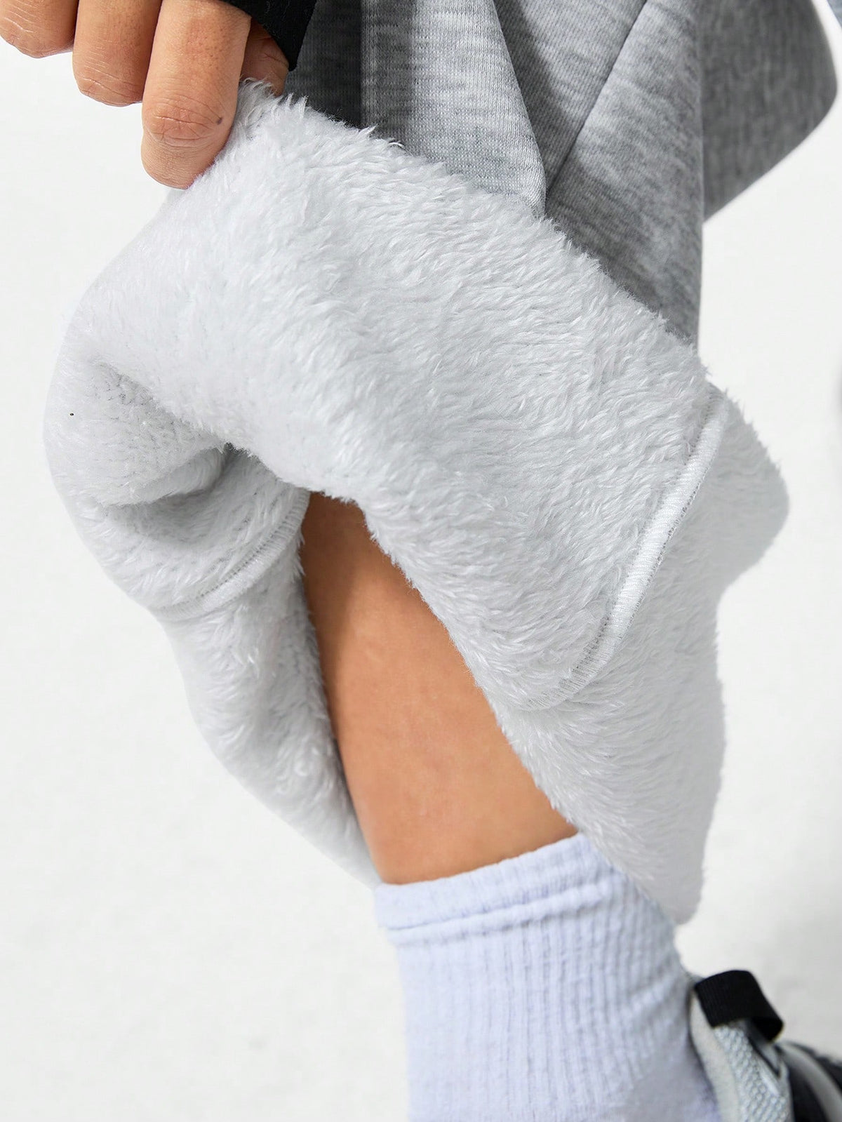 Women's grey fleece straight-leg sweatpants featuring a loose fit and elastic waistband.