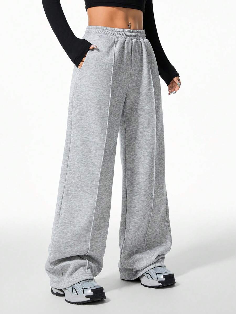 Women's grey fleece straight-leg sweatpants featuring a loose fit and elastic waistband.