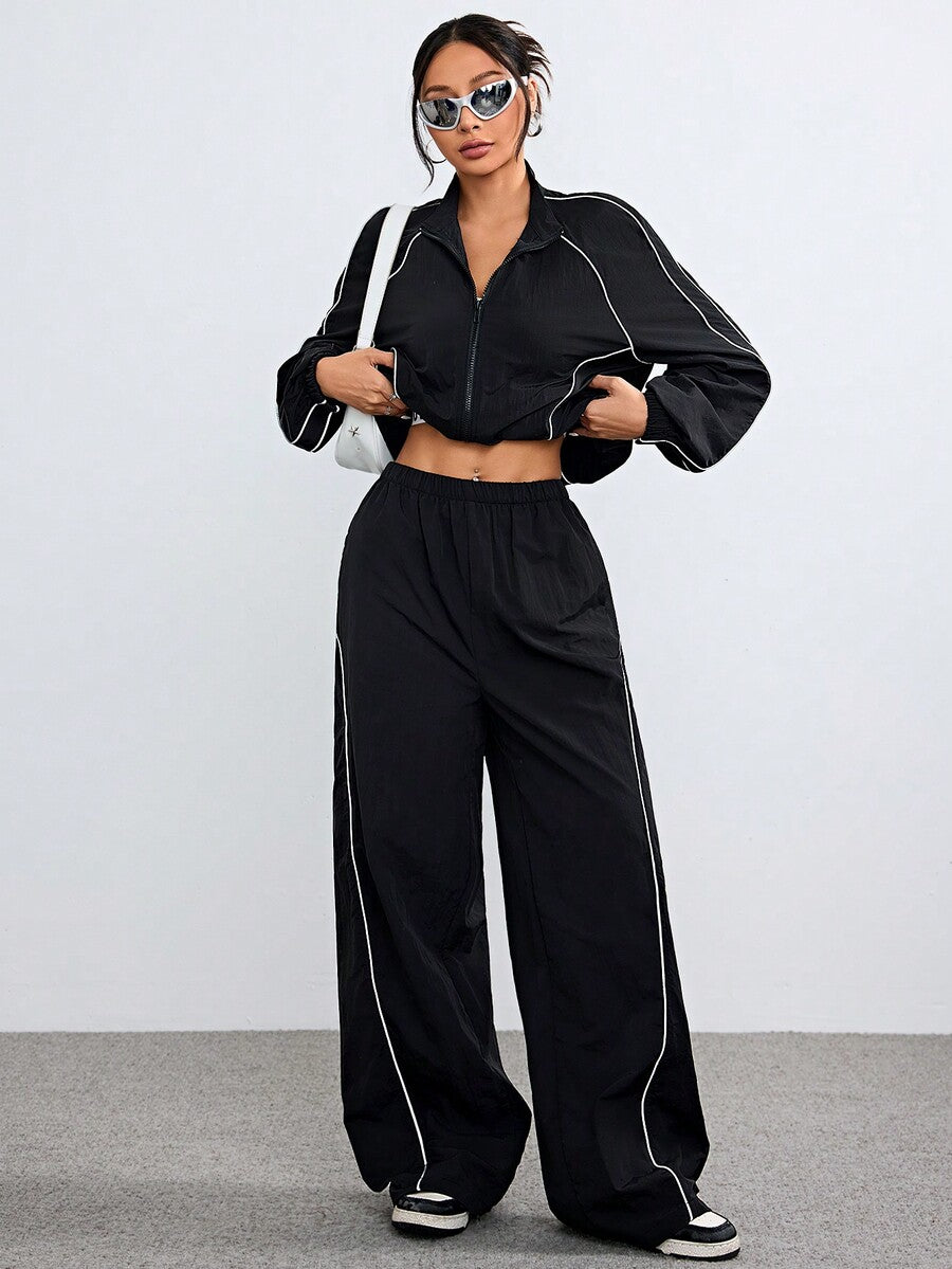 Women's black casual reflective windbreaker sports set featuring a loose stand collar zip jacket and matching unlined pants.