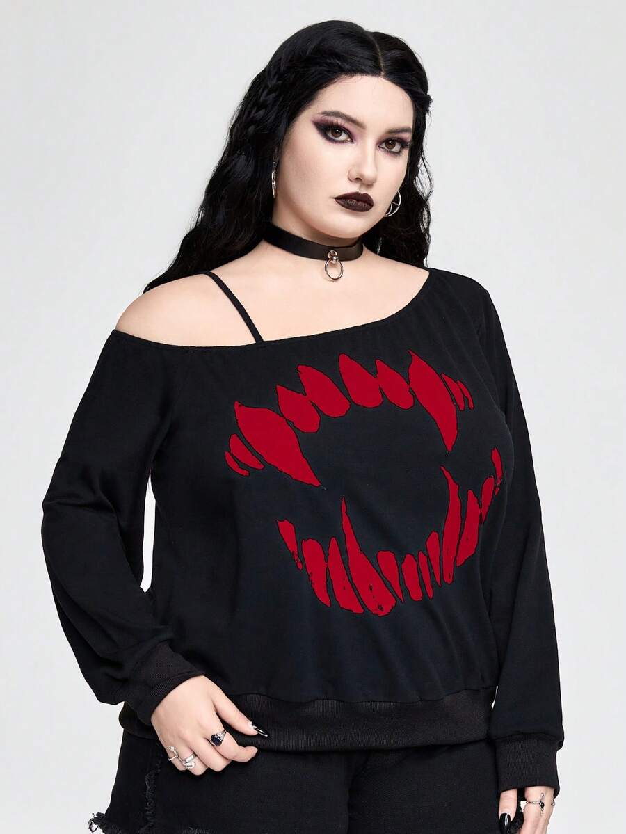 Black women's loose long sleeve gothic sweatshirt with an asymmetrical neckline, strap detail, and fang graphic print.