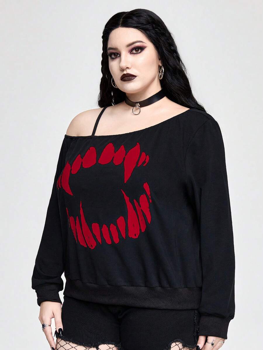 Black women's loose long sleeve gothic sweatshirt with an asymmetrical neckline, strap detail, and fang graphic print.