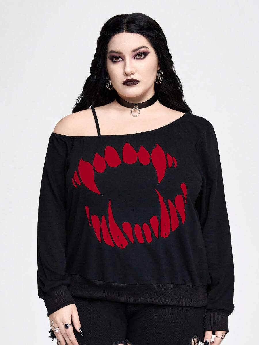 Black women's loose long sleeve gothic sweatshirt with an asymmetrical neckline, strap detail, and fang graphic print.