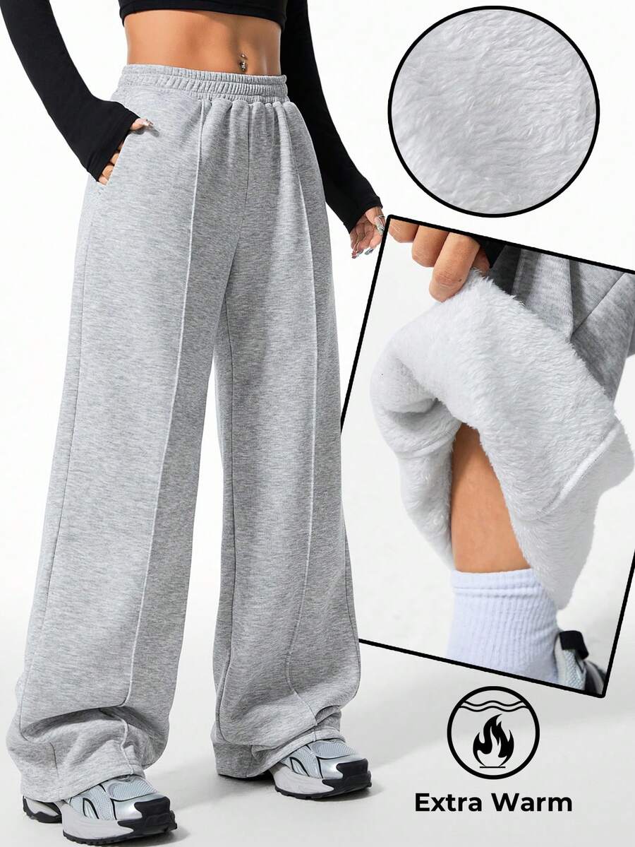 Women's grey fleece straight-leg sweatpants featuring a loose fit and elastic waistband.
