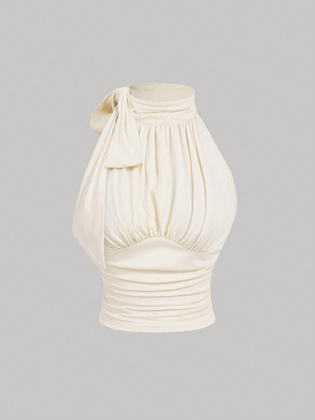 Women's sleeveless high-neck halter crop top in apricot with ruched knot front detailing.