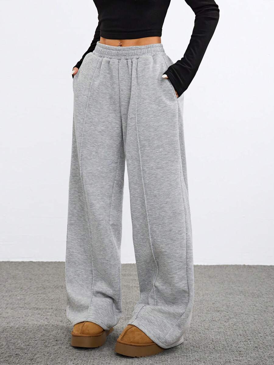 Women's grey fleece straight-leg sweatpants featuring a loose fit and elastic waistband.