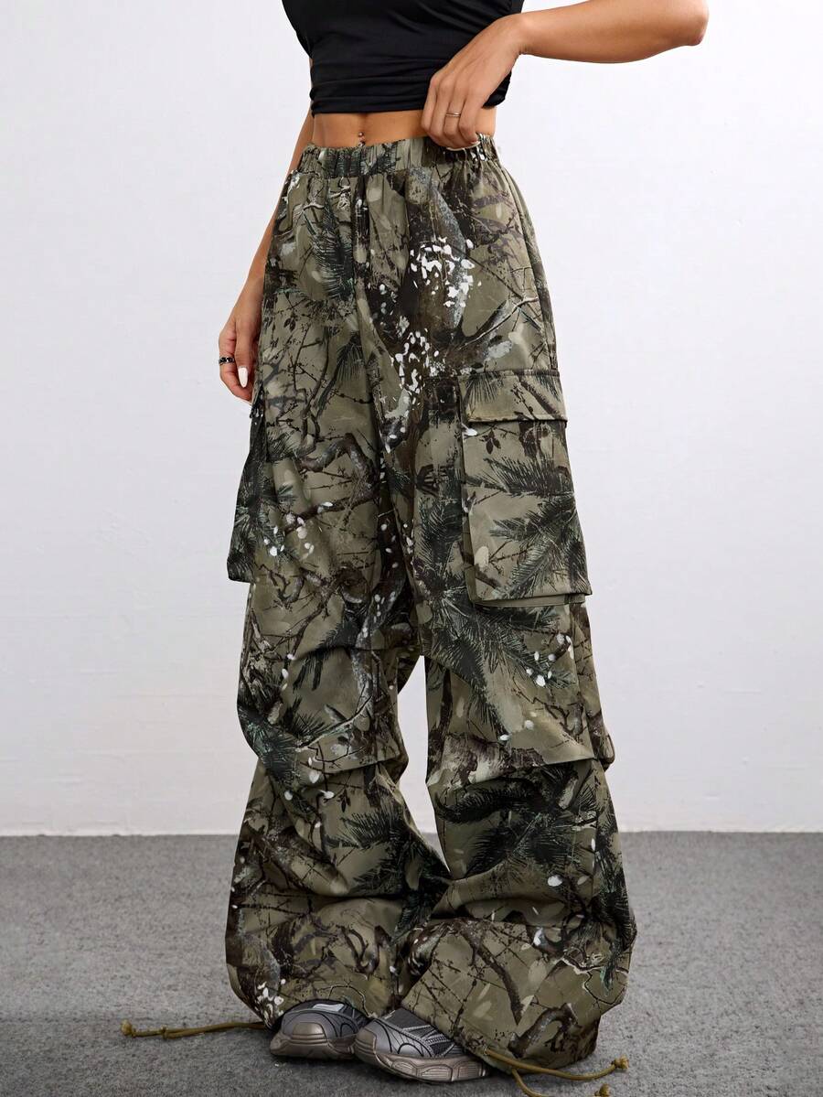 Women's high waist wide leg cargo pants featuring a black and white tree branch print and adjustable drawstring closure.