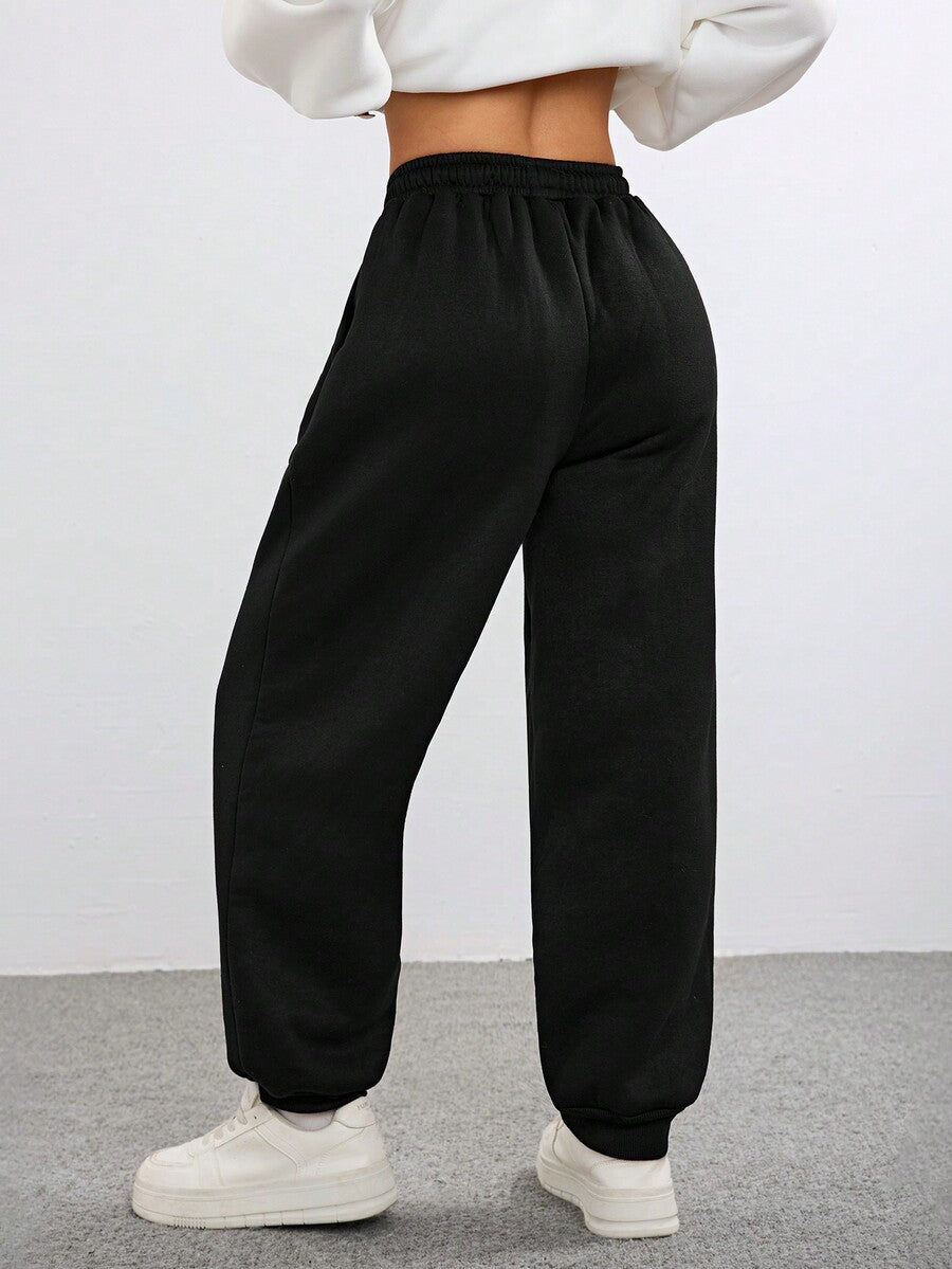 Women's black casual sweatpants featuring an adjustable drawstring waistband, loose straight cut, and soft warm knitted fabric.