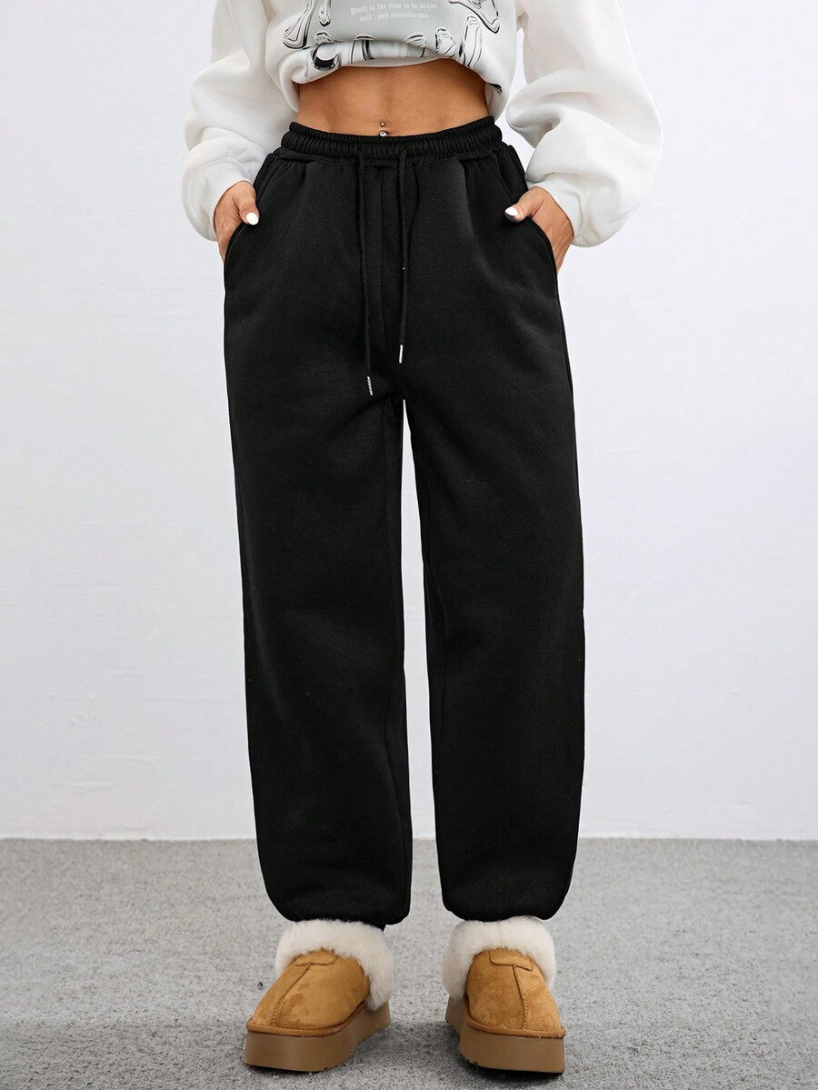 Women's black casual sweatpants featuring an adjustable drawstring waistband, loose straight cut, and soft warm knitted fabric.