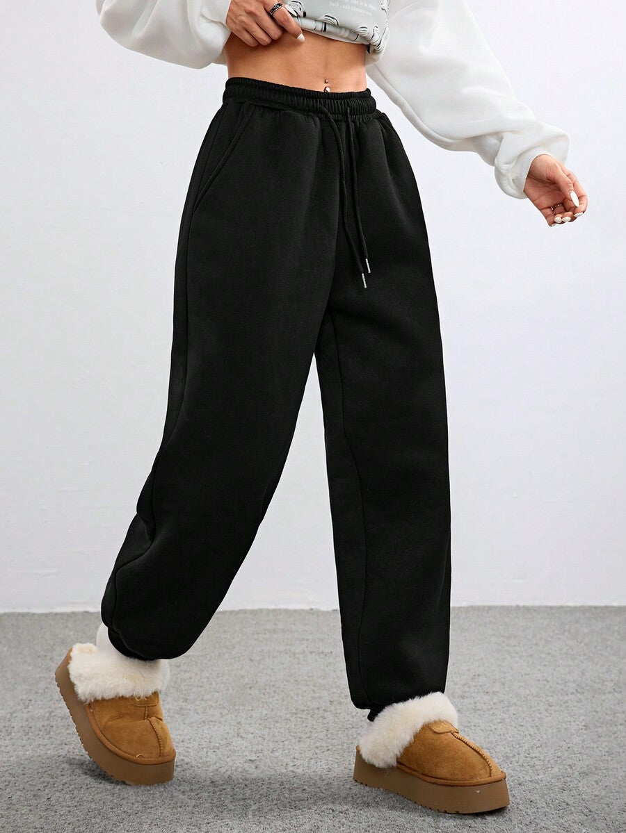 Women's black casual sweatpants featuring an adjustable drawstring waistband, loose straight cut, and soft warm knitted fabric.