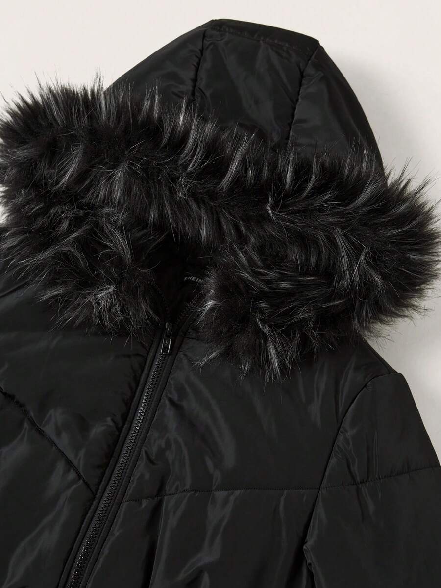 Women's brown cropped puffer jacket featuring a faux fur trimmed hood, front zipper, and ribbed hem.