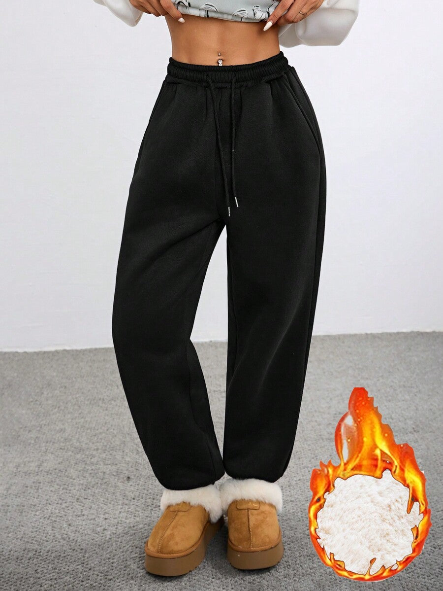 Women's black casual sweatpants featuring an adjustable drawstring waistband, loose straight cut, and soft warm knitted fabric.