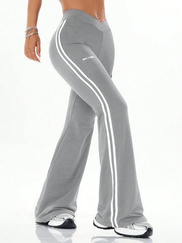 Women's high waist flare leg pants with side stripe tape detailing and an elastic waistband.