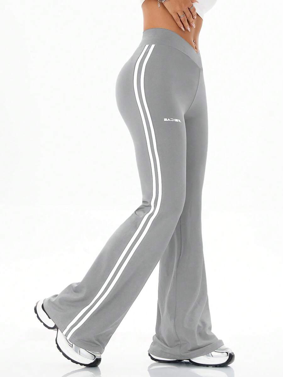 Women's high waist flare leg pants with side stripe tape detailing and an elastic waistband.