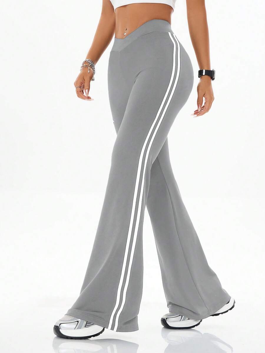 Women's high waist flare leg pants with side stripe tape detailing and an elastic waistband.