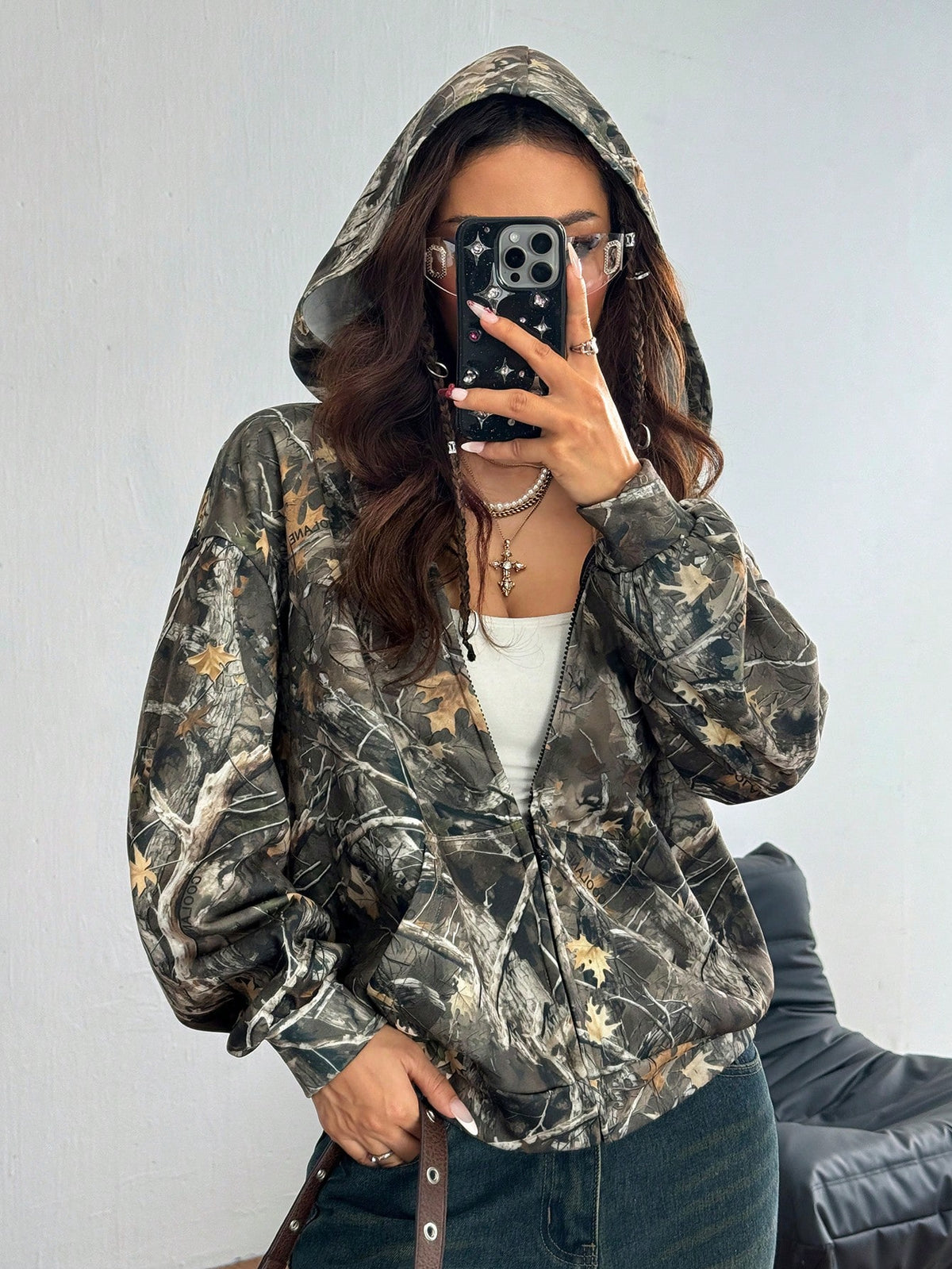 Women's army green camo zip up hoodie with drop shoulder sleeves, front pockets, and drawstring hood