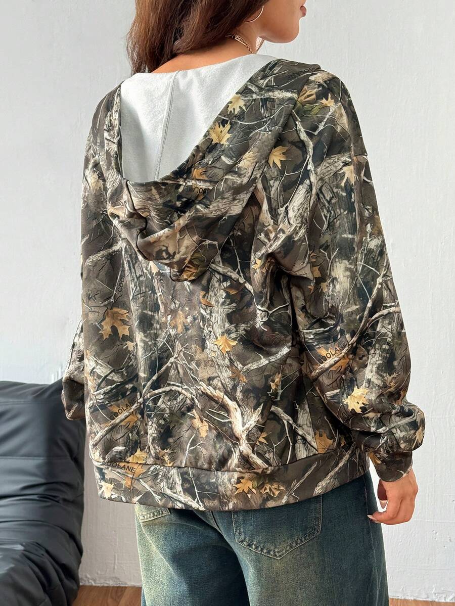 Women's army green camo zip up hoodie with drop shoulder sleeves, front pockets, and drawstring hood