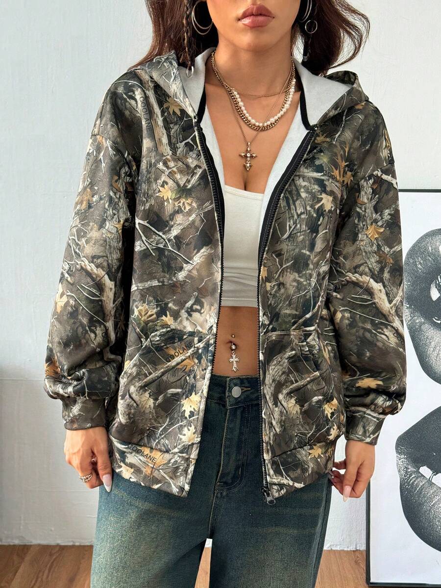 Women's army green camo zip up hoodie with drop shoulder sleeves, front pockets, and drawstring hood