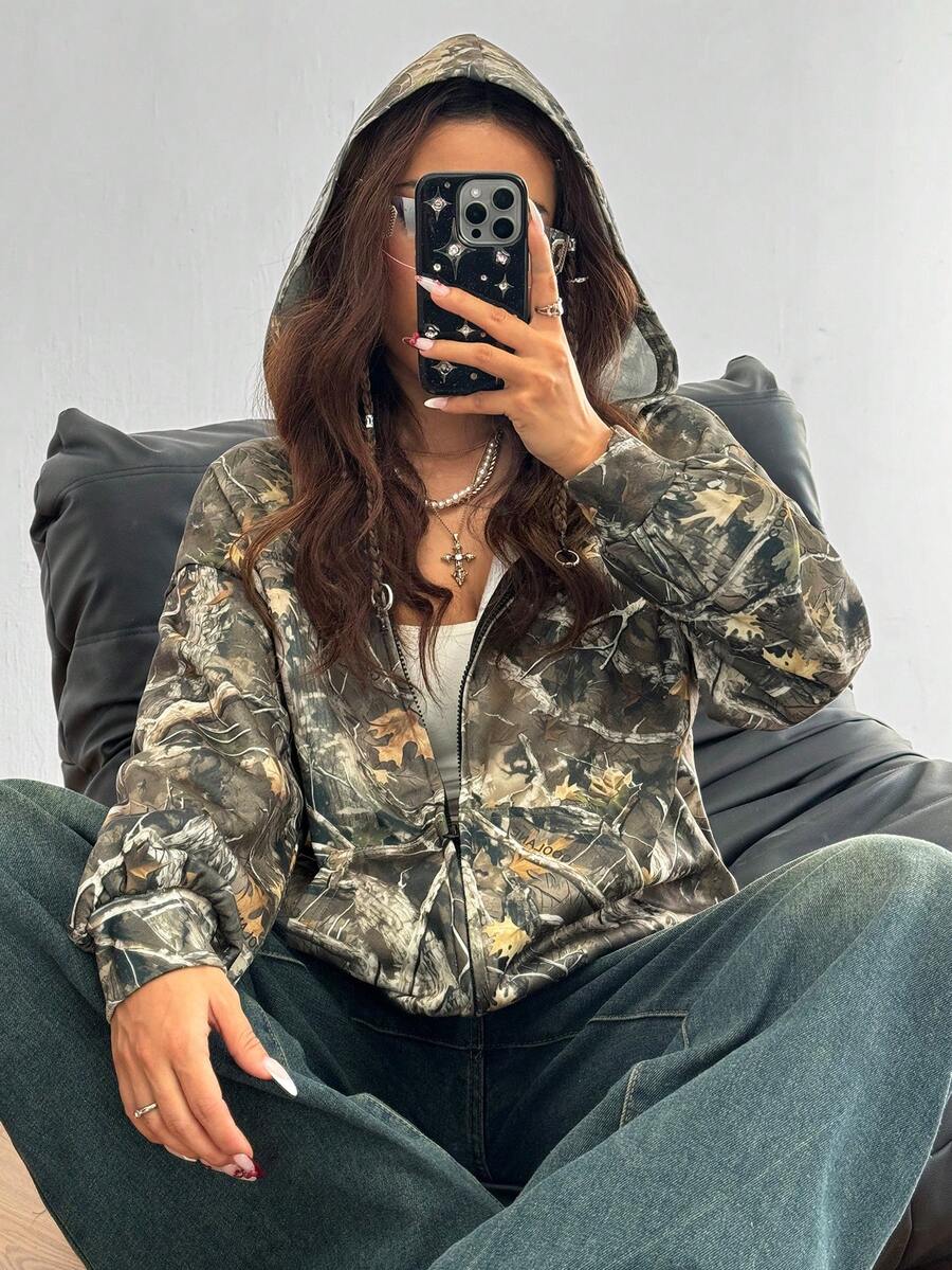 Women's army green camo zip up hoodie with drop shoulder sleeves, front pockets, and drawstring hood