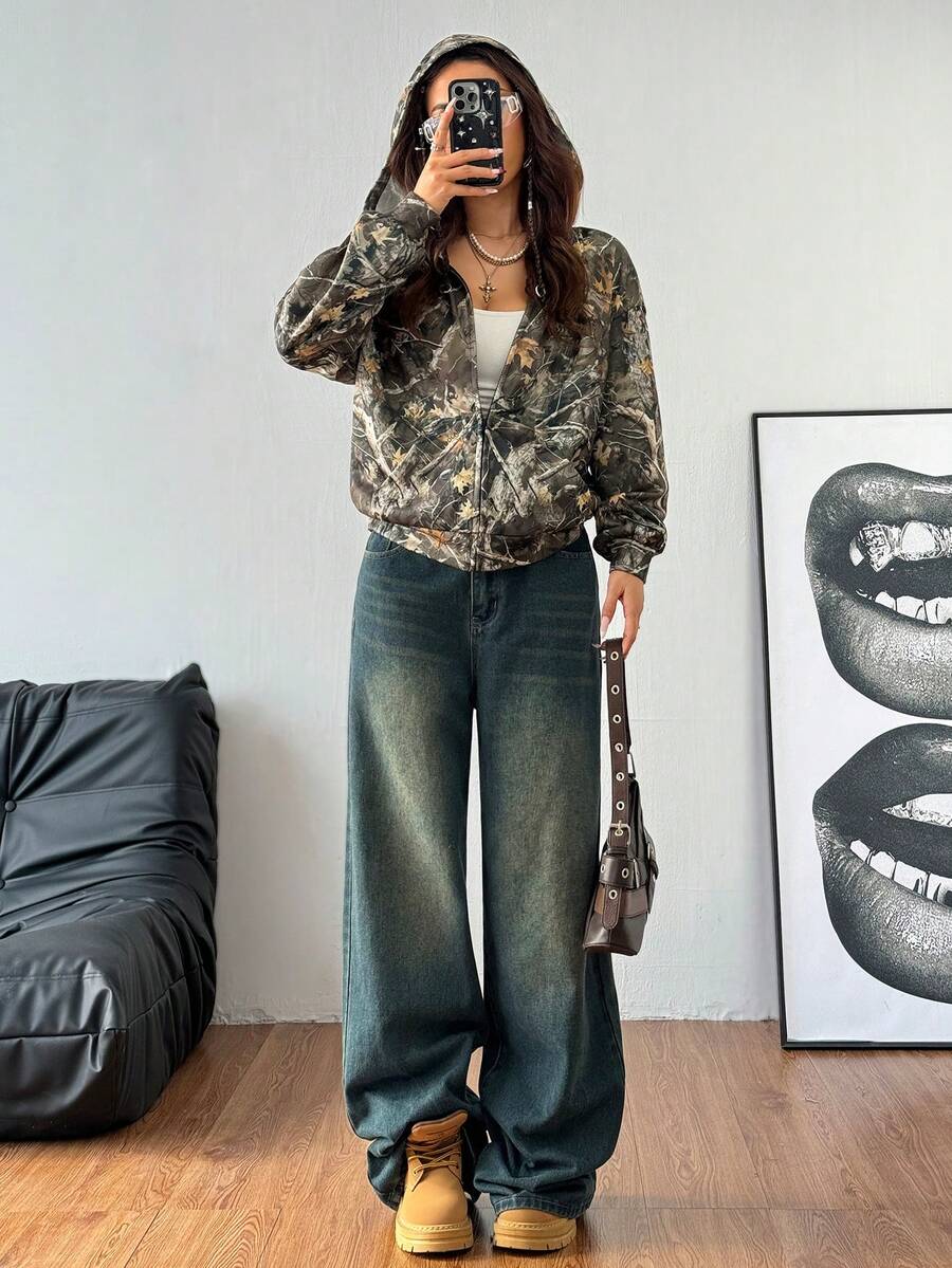 Women's army green camo zip up hoodie with drop shoulder sleeves, front pockets, and drawstring hood